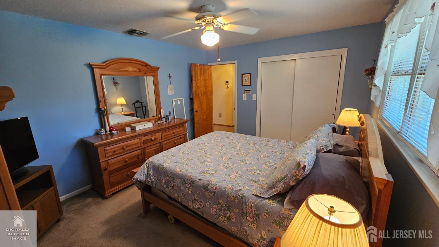 263 New Road Monmouth Junction, NJ 08852 - Photo 59 of 70 a bedroom with a bed and dresser with mirror