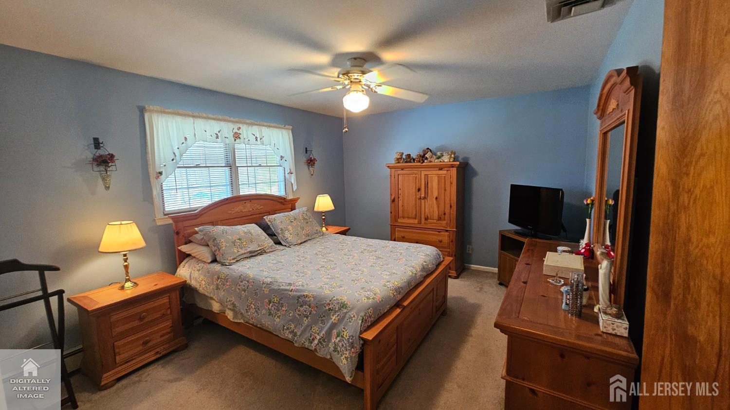 263 New Road Monmouth Junction, NJ 08852 - Photo 62 of 70 a bedroom with a bed and a flat tv screen on dresser