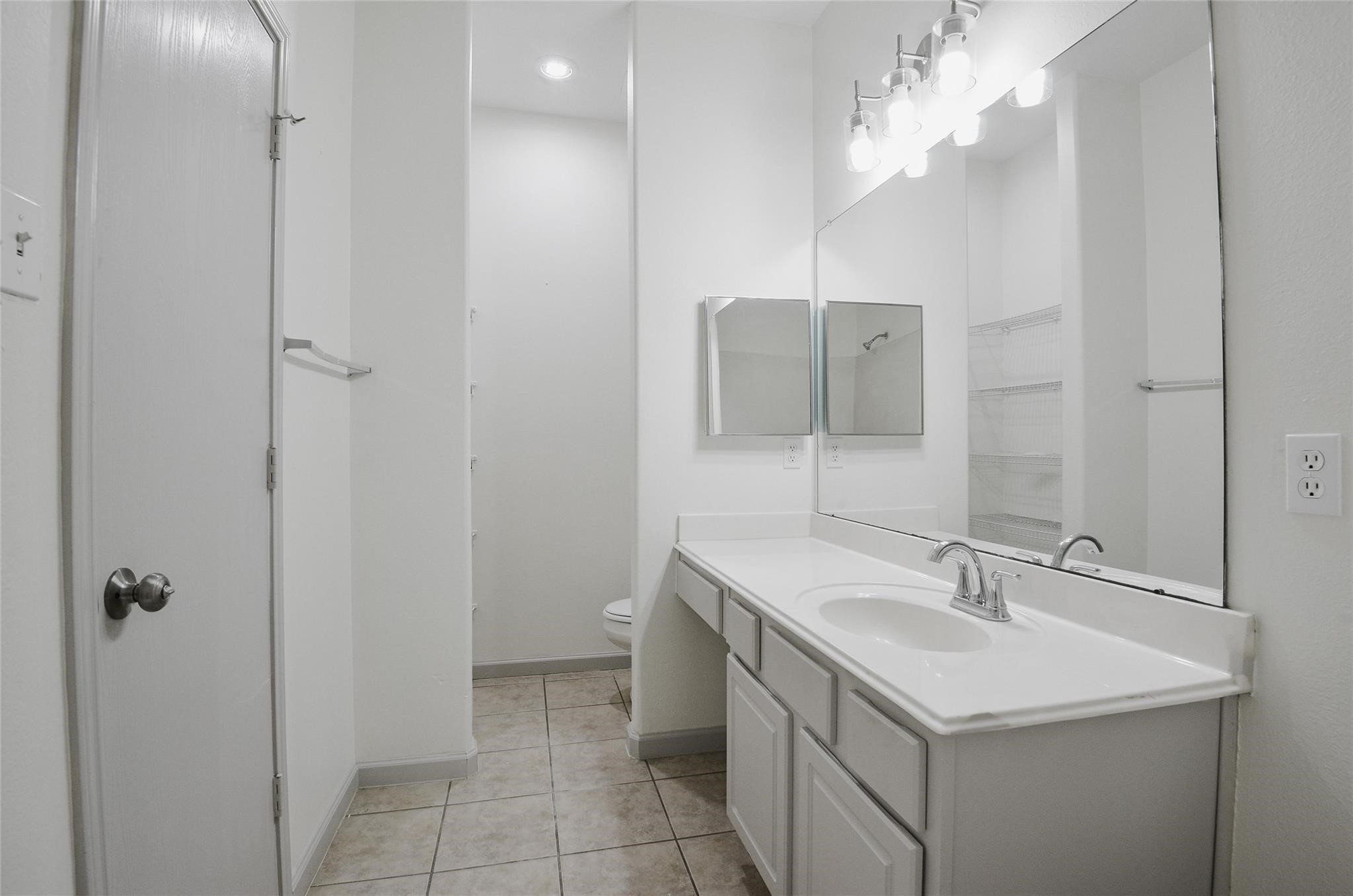6627 Stonecross Creek Lane Katy, TX 77449 - Photo 20 of 30 a bathroom with a sink vanity and a mirror