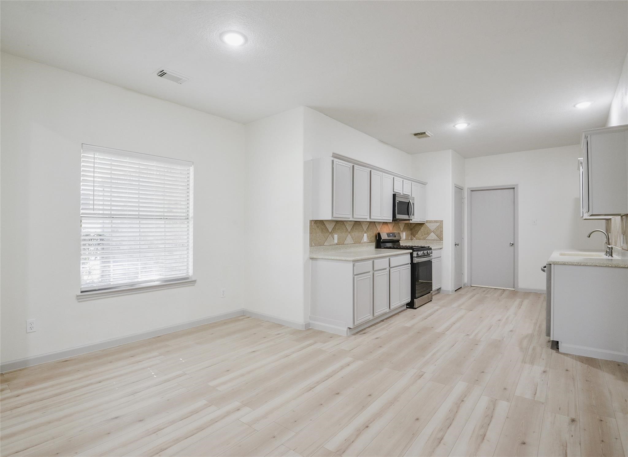 6627 Stonecross Creek Lane Katy, TX 77449 - Photo 6 of 30 a kitchen with white cabinets and appliances