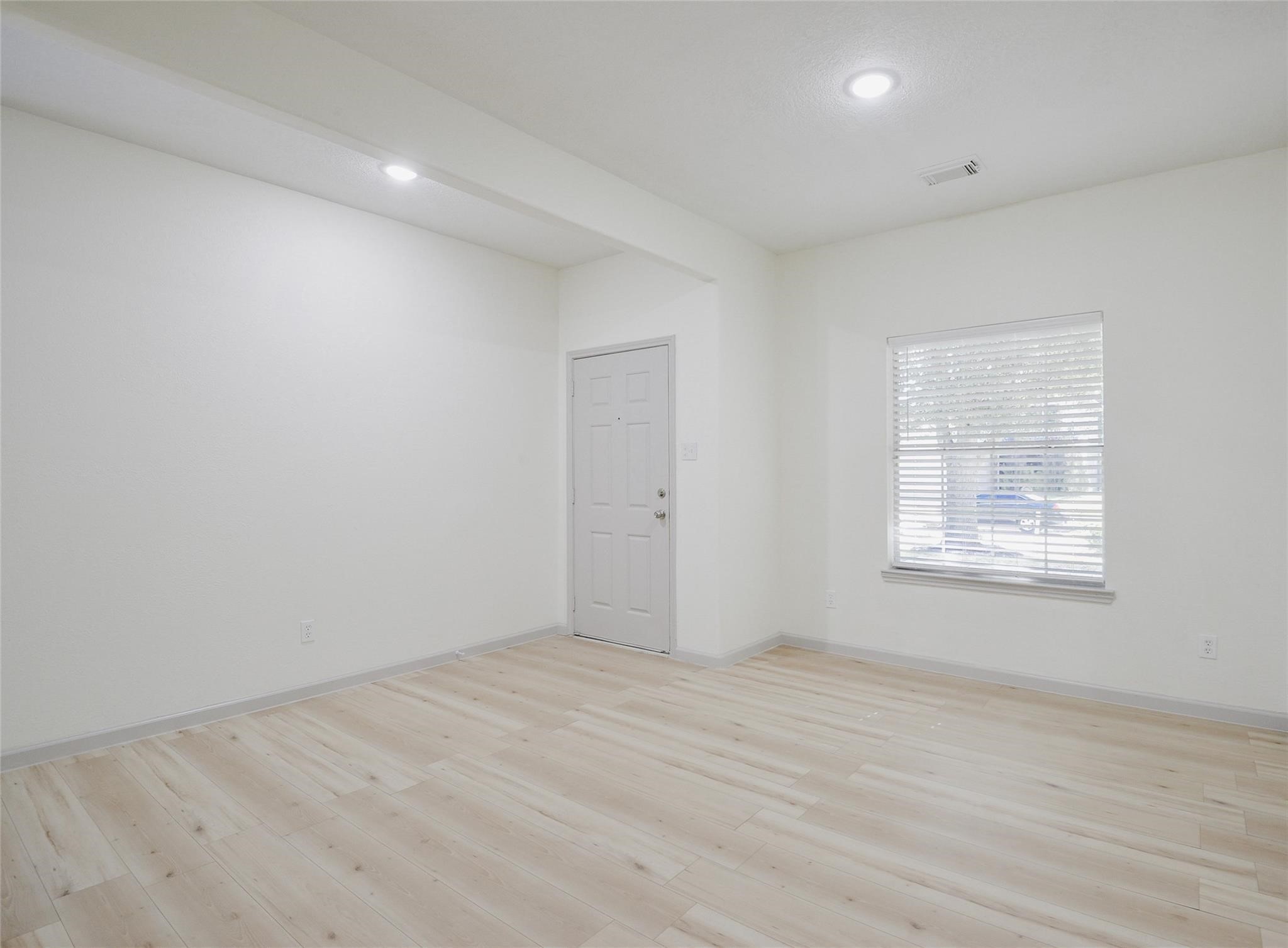 6627 Stonecross Creek Lane Katy, TX 77449 - Photo 7 of 30 wooden floor in an empty room with a window