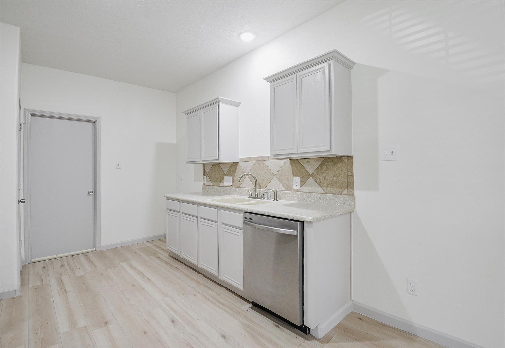 6627 Stonecross Creek Lane Katy, TX 77449 - Photo 9 of 30 a view of cabinets with wooden floor