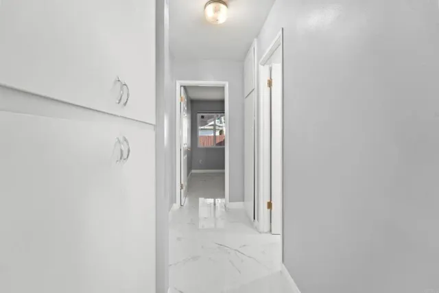 a view of a bathroom from a corridor