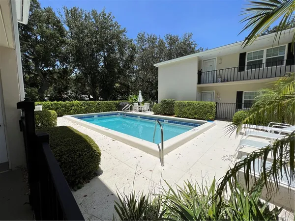 a view of a house with swimming pool and sitting area