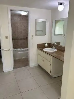 a bathroom with a granite countertop sink a mirror and a