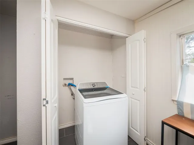 a utility room with sink dryer and washer