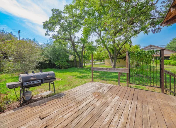 a view of a park with wooden floor and bench