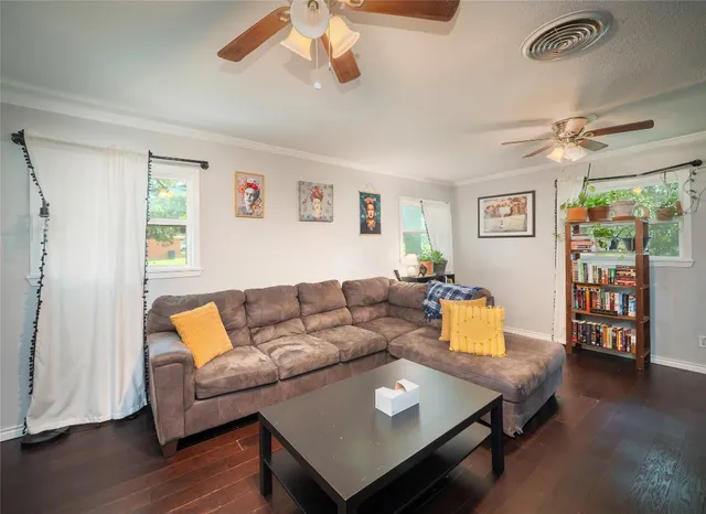 a living room with furniture and wooden floor