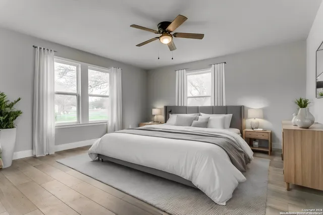 a bedroom with bed window and ceiling fan