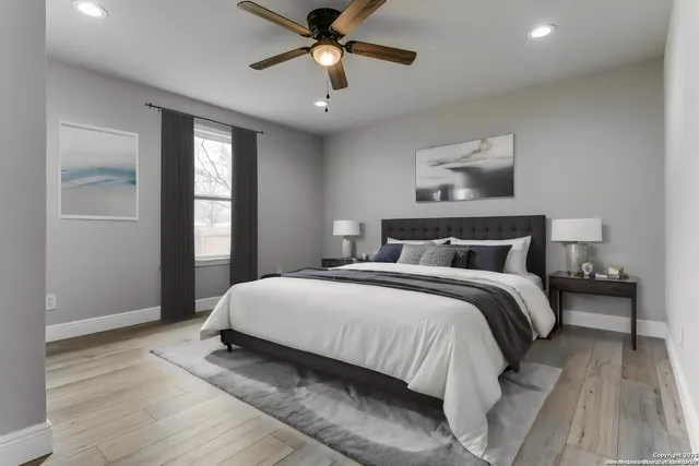 a bedroom with a bed and a chandelier