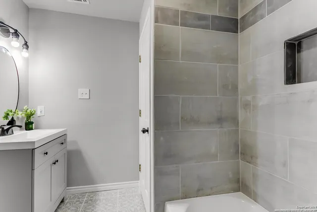 a bathroom with a shower and a sink