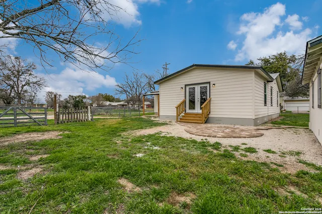 a front view of house with yard and trees