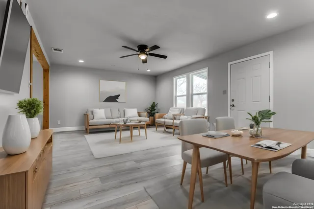 a living room with furniture potted plant and a window