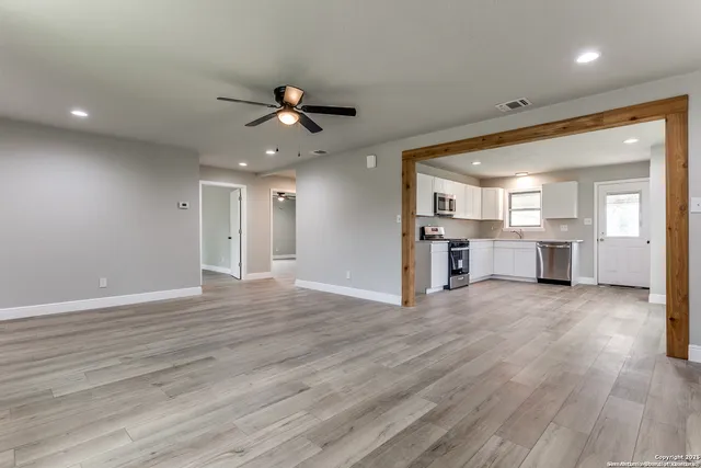 a view of a kitchen with wooden floor and a kitchen