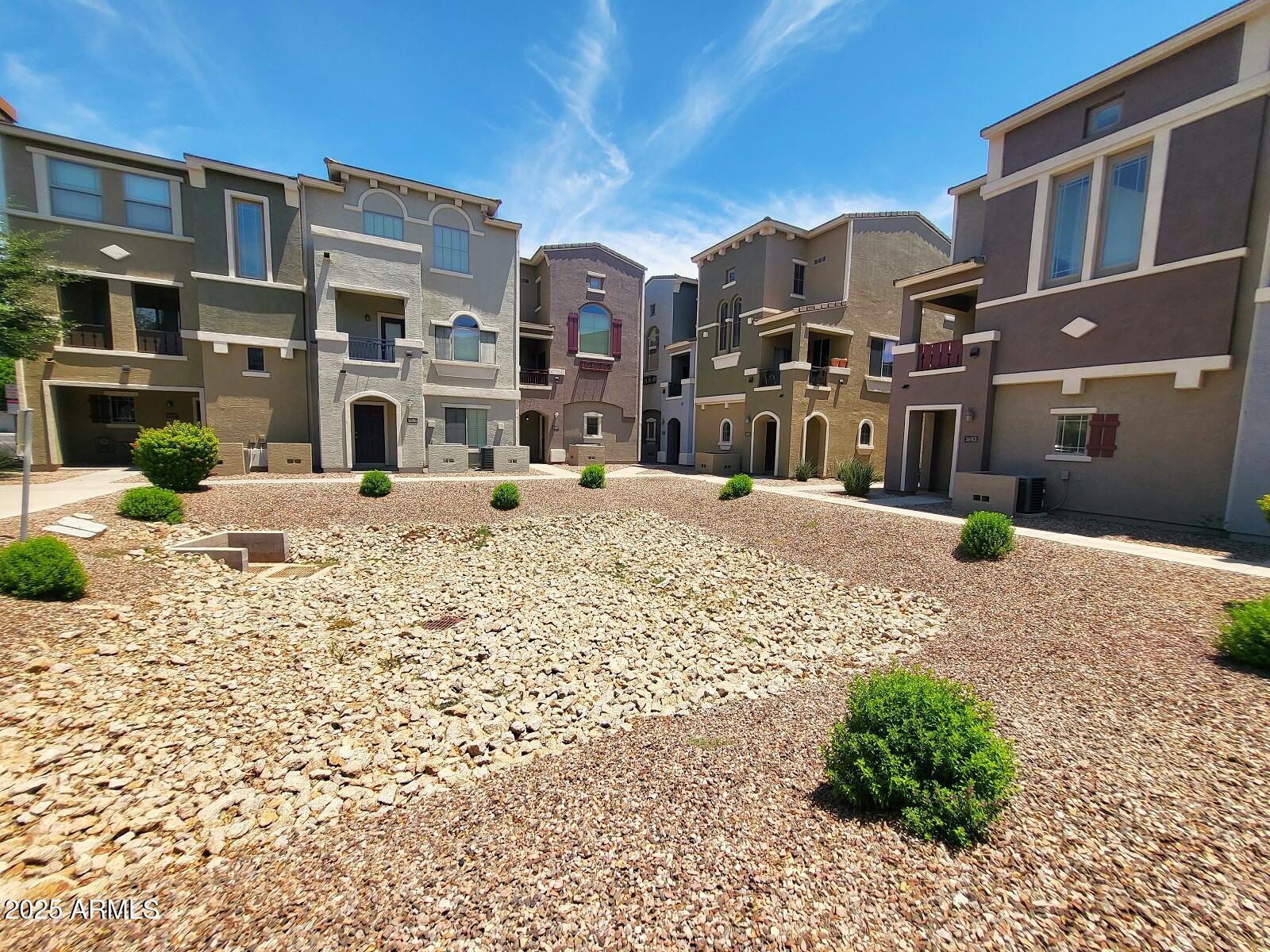 2402 East 5th Street, Unit 1686 Tempe, AZ 85288 - Photo 1 of 25 a view of a house with a snow on the road