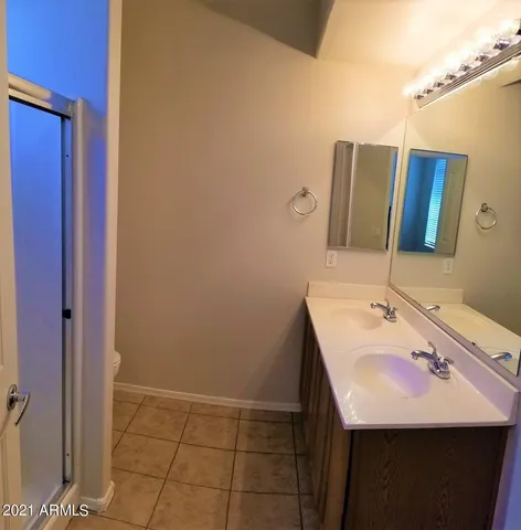 a bathroom with a glass door shower and a toilet