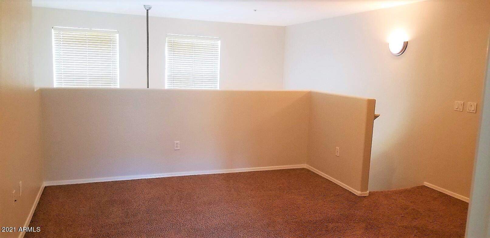 2402 East 5th Street, Unit 1686 Tempe, AZ 85288 - Photo 21 of 25 an empty room with windows