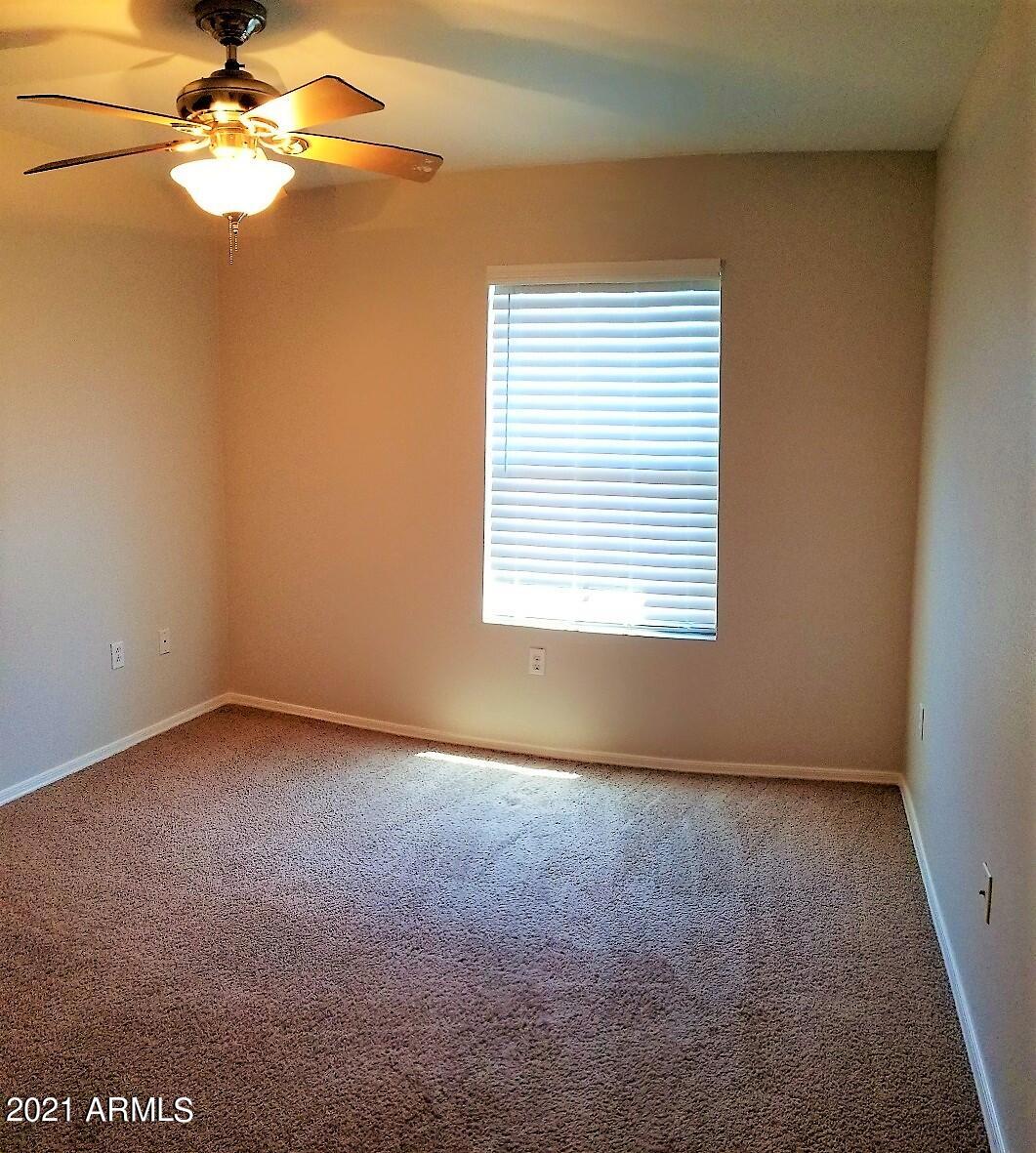 2402 East 5th Street, Unit 1686 Tempe, AZ 85288 - Photo 23 of 25 an empty room with windows and fan