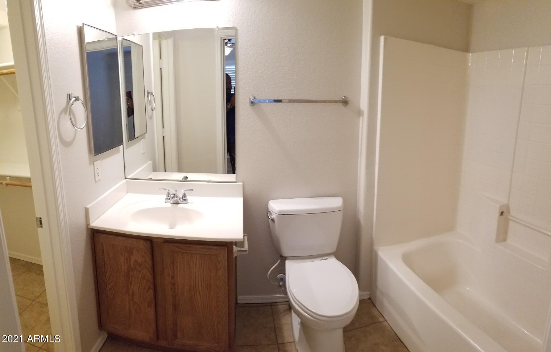 2402 East 5th Street, Unit 1686 Tempe, AZ 85288 - Photo 6 of 25 a bathroom with a sink toilet and shower