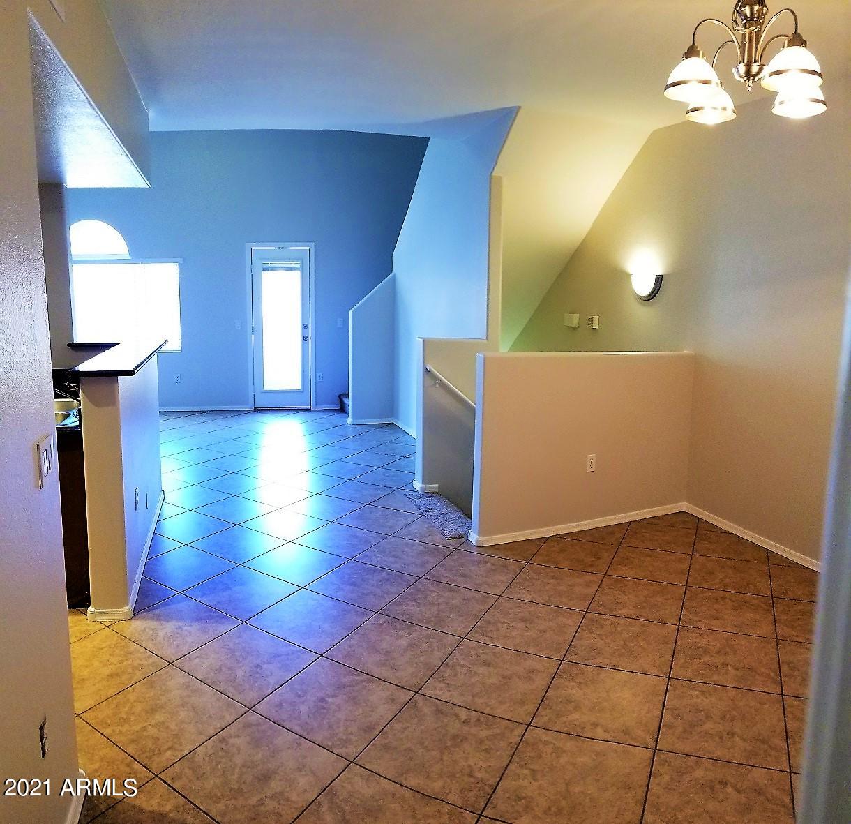 2402 East 5th Street, Unit 1686 Tempe, AZ 85288 - Photo 9 of 25 a view of a livingroom with a chandelier