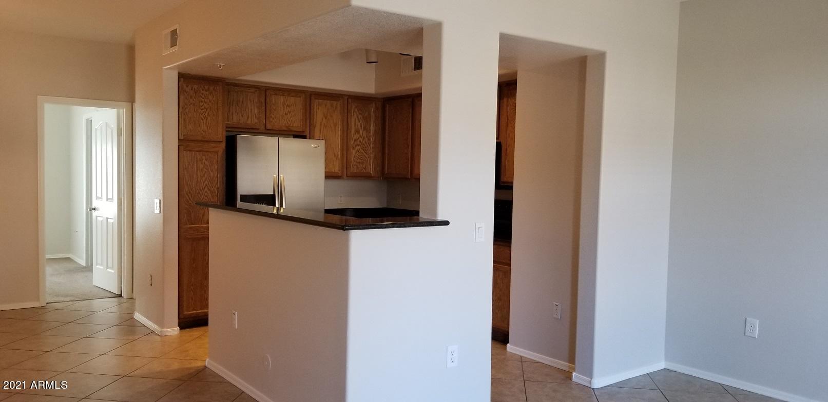 2402 East 5th Street, Unit 1686 Tempe, AZ 85288 - Photo 10 of 25 a hallway with sink and mirror