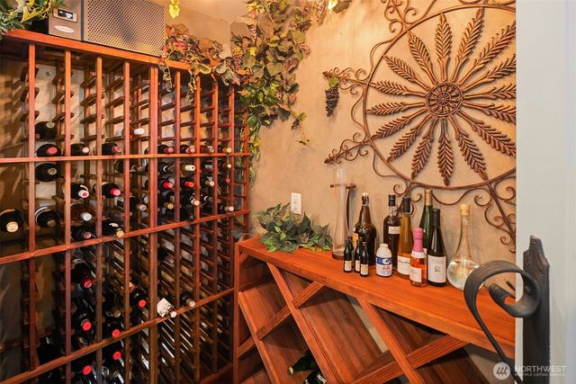 a bathroom with a granite countertop sink a mirror and a toilet