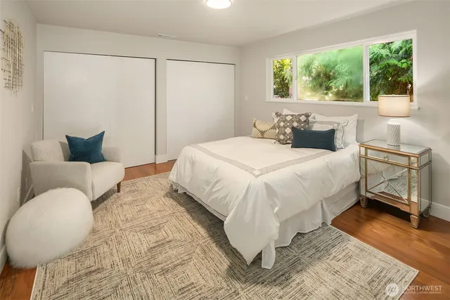 a bathroom with a granite countertop sink a mirror and a shower
