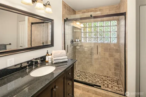 a spacious bedroom with a bed and a lamp