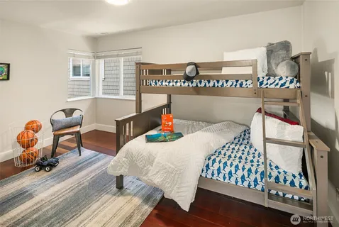 a living room with furniture large windows and a fireplace