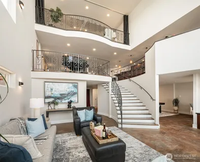 a living room with furniture and a dining table