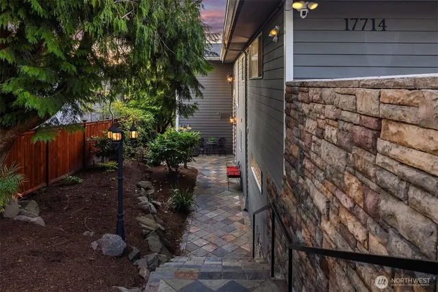 a backyard of a house with table and chairs potted plants