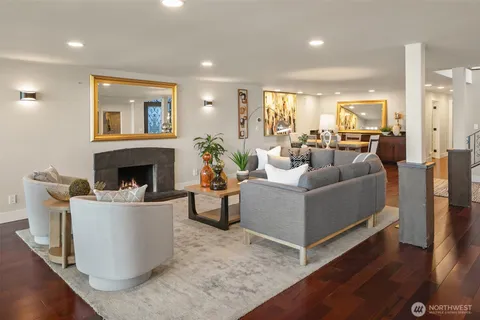 a kitchen with stainless steel appliances a dining table chairs sink and wooden cabinets