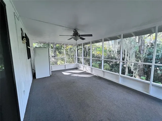 a view of a room with wooden floor and windows