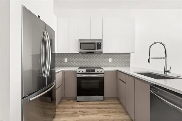 a kitchen with a sink stove and refrigerator