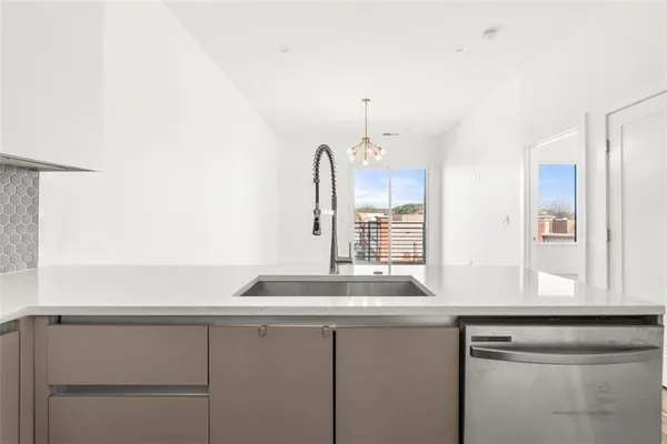 a kitchen with a sink cabinets and window
