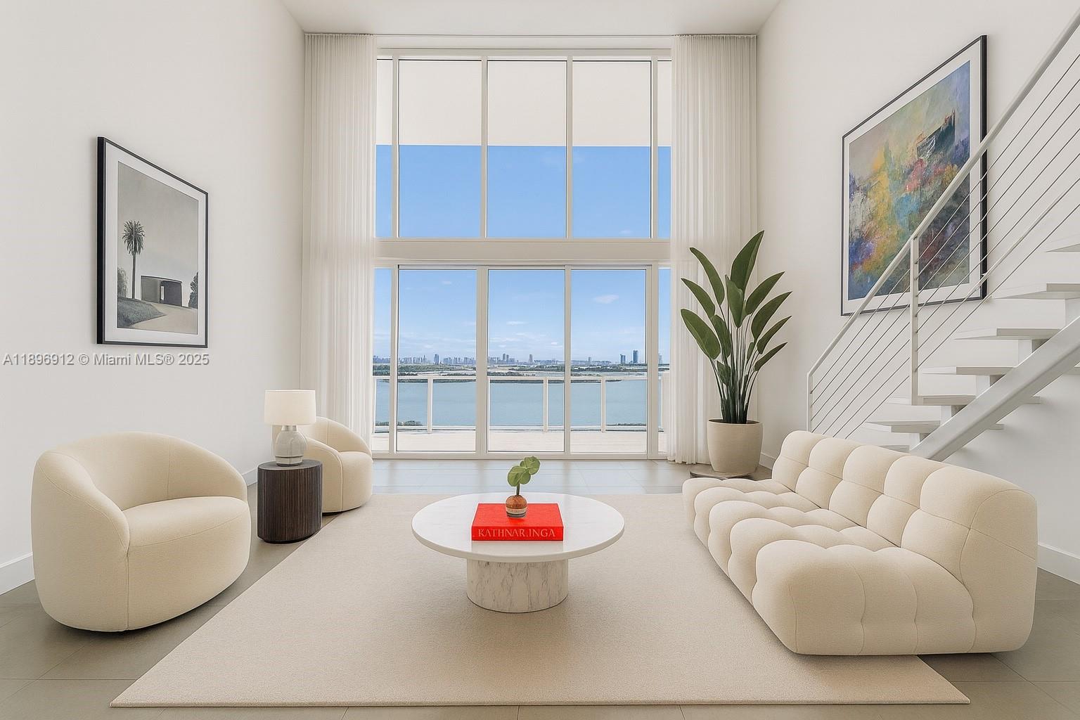 1040 Biscayne Boulevard, Unit 2402 Miami, FL 33132 - Photo 1 of 17 a living room with furniture and a potted plant