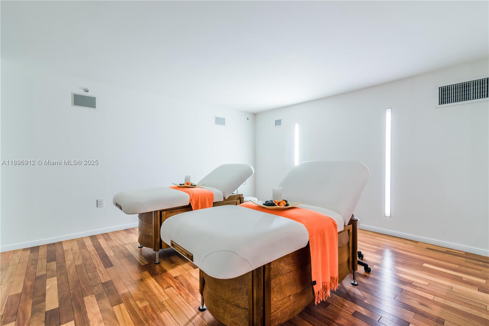 1040 Biscayne Boulevard, Unit 2402 Miami, FL 33132 - Photo 15 of 17 a bedroom with two beds and wooden floor