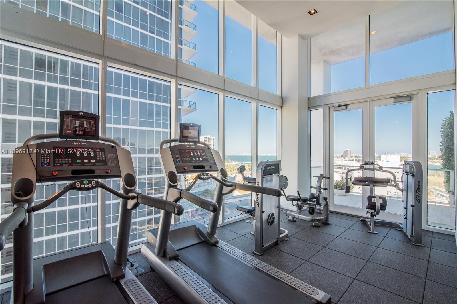 1040 Biscayne Boulevard, Unit 2402 Miami, FL 33132 - Photo 16 of 17 a view of a livingroom with furniture and floor to ceiling window