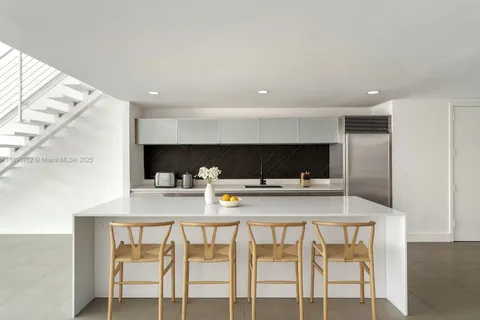 a kitchen with a table and chairs in it