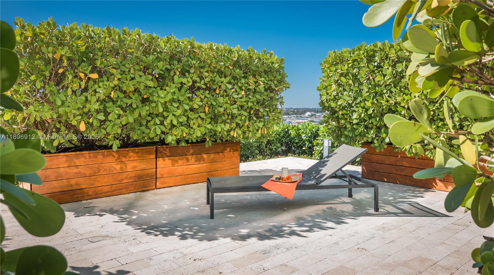 1040 Biscayne Boulevard, Unit 2402 Miami, FL 33132 - Photo 10 of 17 a backyard of a house with table and chairs