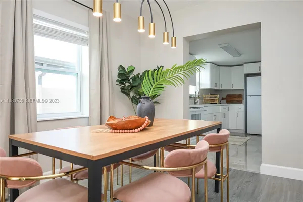 a kitchen with stainless steel appliances white cabinets and a refrigerator