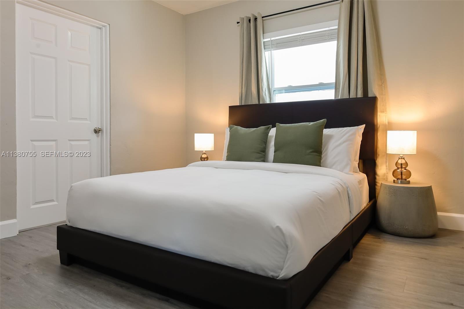 2761 Southwest 33rd Avenue, Unit 1 Miami, FL 33133 - Photo 19 of 46 a large bed sitting in a bedroom next to a window