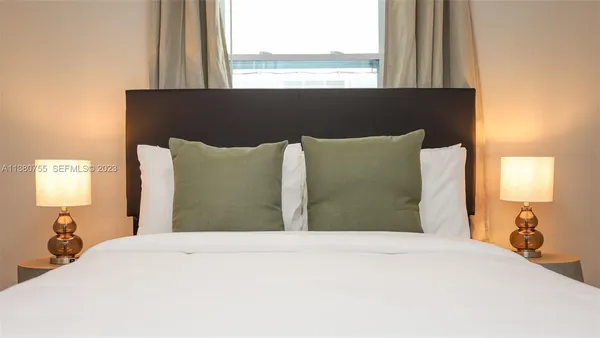 a bedroom with a bed and a wall painting