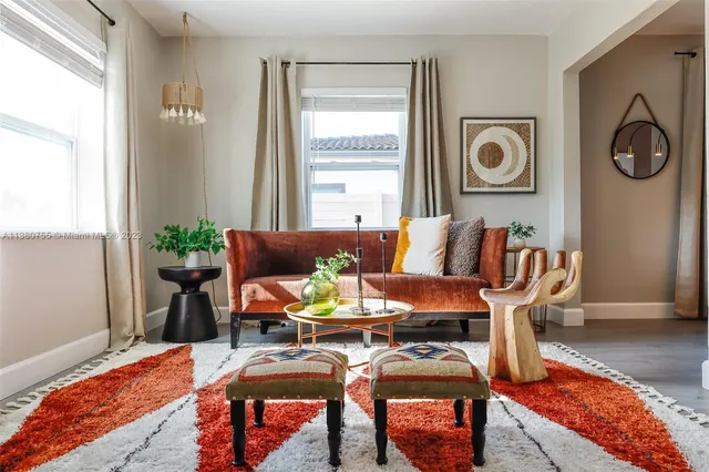 a living room with furniture and wooden floor