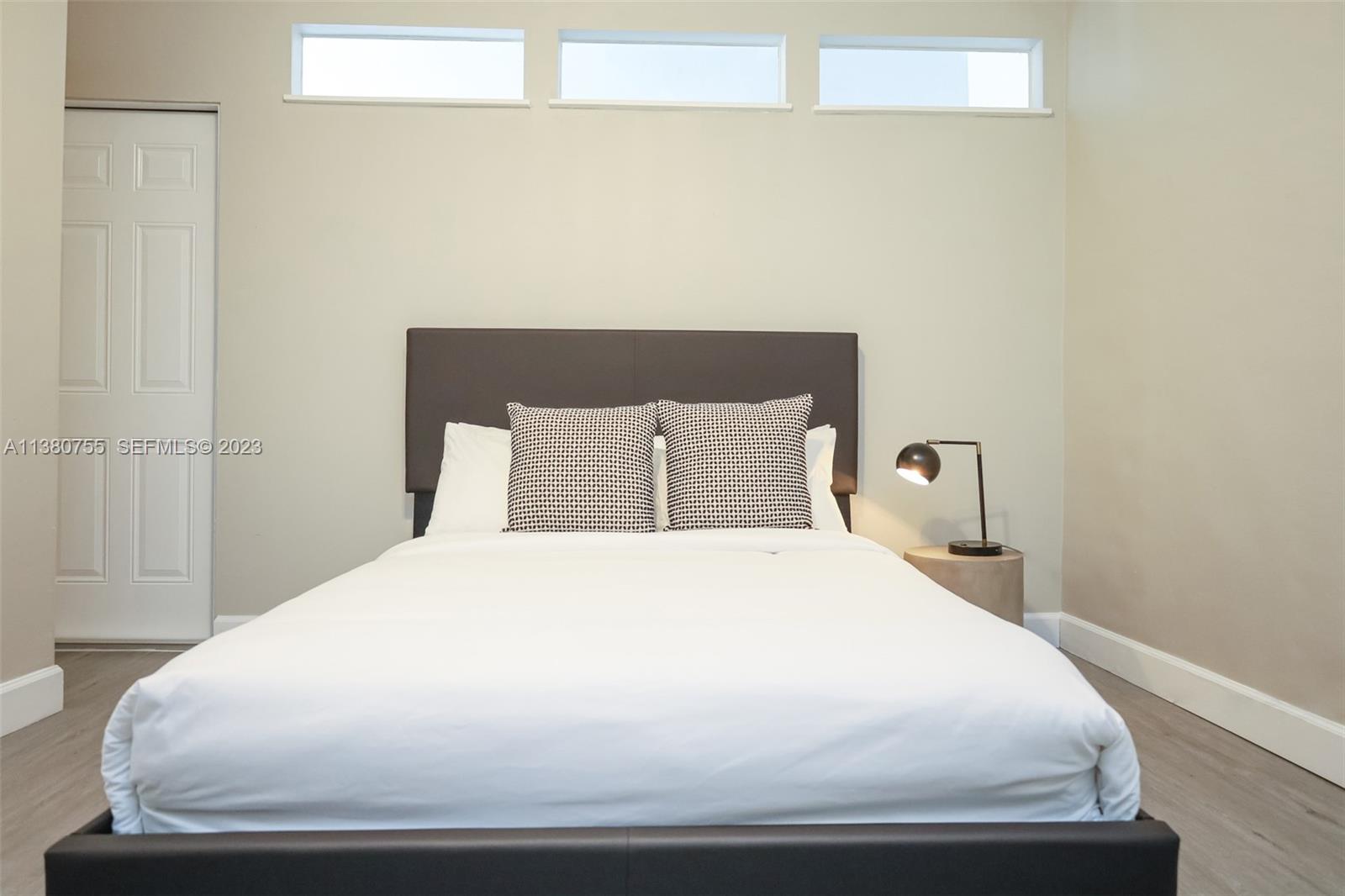 2761 Southwest 33rd Avenue, Unit 1 Miami, FL 33133 - Photo 22 of 46 a large bed sitting in a bedroom next to a window