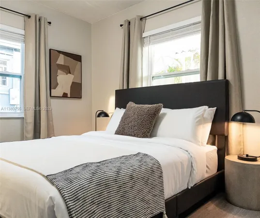 a bedroom with a bed and a potted plant