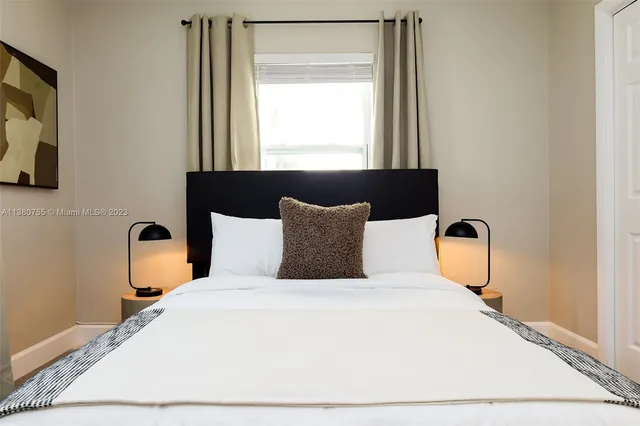 a bedroom with a bed and window