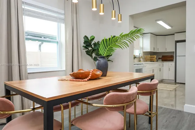 a view of a dining room with furniture and a potted plant