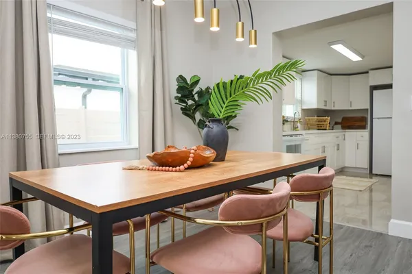 a view of a dining room with furniture and a potted plant