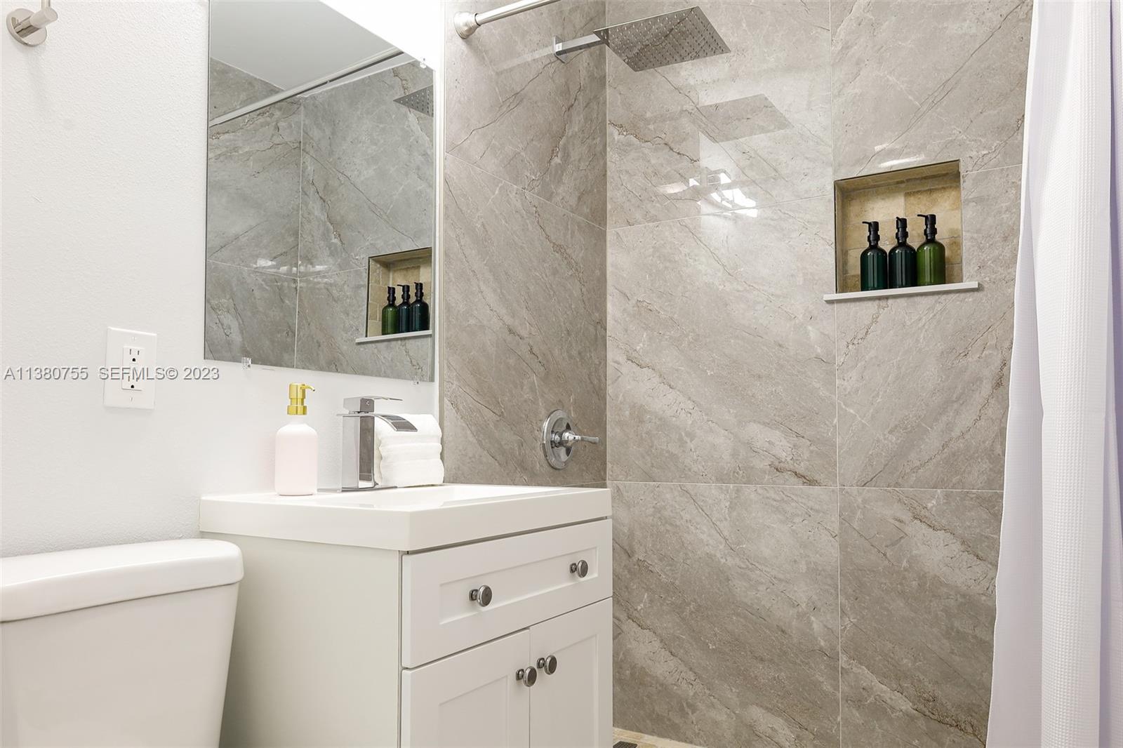 2761 Southwest 33rd Avenue, Unit 1 Miami, FL 33133 - Photo 31 of 46 a bathroom with a sink and a mirror